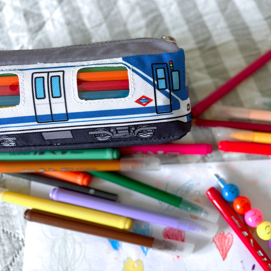 Estuche escolar con diseño de tren, lápices de colores y dibujo infantil sobre manta blanca