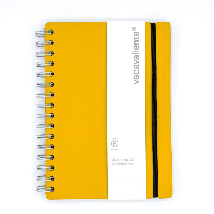 Cuaderno A5 amarillo con espiral y banda elástica negra, marca Vacavaliente.