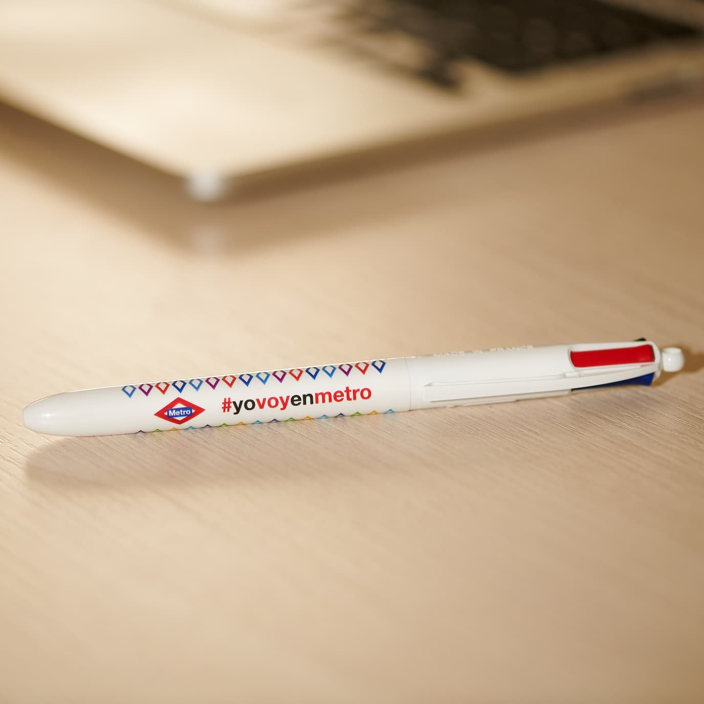Bolígrafo promocional del Metro de Madrid con hashtag #yovoyenmetro sobre escritorio